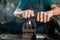 Close-up of a steel lathe with an iron insert, and iron is being machined in the machine, with mechanics closely operating the