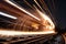 close-up of steel rail, with sparks flying from the wheels of a passing train