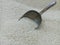 Close up of the steel rice scoop is inserted in the rice.