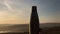 Close-up of steel thermo bottle with cap on background of sunset.