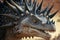 close-up of stegosaurus' face, with its distinctive plates and teeth visible