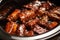 close-up of sticky ribs in a slow cooker