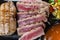 Close Up Still Life of Roasted Tuna Steaks Crusted with Herbs and Sesame Seeds on Dark Gray Surface