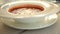 Close-up of stirring up sour cream in borsch served in cafe or restaurant