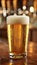 Close up stock photo of beer glass with frothy foam and water droplets, detailed shot