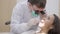 A close-up of a stomatologist wearing a mask. In a dental clinic, a private dentist is treating teeth. A male doctor works with a