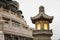 Close up stone Chinese Buddhist lamp with light inside near big buddha in Hong Kong.