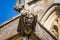 Close up of a stone gargoyle on the walls of Sherborne Abbey in Sherborne, Dorset, UK