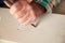 Close Up Of Stone Mason At Work On Carving In Studio