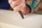 Close Up Of Stone Mason At Work On Carving In Studio