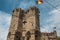 Close-up of stone watch-tower and flag in the Gravensteen Castle at Ghent.