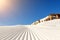 Close-up straight line rows of freshly prepared groomed ski slope piste with bright shining sun and clear blue sky