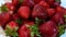 Close up strawberry berries slow rotate in a plate. Selective focus