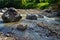 Close-up streams of water between mountain stones