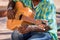 Close up of a street musician playing a guitar in Trinidad Cuba