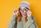 Close-up strict young woman, isolated on yellow background. Jealous pretty girl