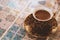 Close-up strong coffee cup on a blurred background oriental tiles