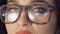 Close up strong look of pretty girl`s eyes in glasses