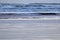 Close up on strong powerful breaking waves on sandy beach of hendaye, france