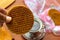 Close-up of stroopwafel with a hand bringing it to a cup of coffee