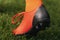 Close-up stud shoe on green lawn background. Soccer football cleat on grass pitch