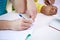 Close up of students hands writing to notebooks