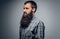 Close up studio portrait of bearded male dressed in a plaid shir