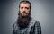 Close up studio portrait of bearded male dressed in a plaid shir