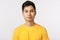 Close-up studio shot asian charming, modern hipster man in yellow t-shirt, smiling with confident, assertive expression