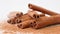 Close up studio shot of food ingredient. A pile of brown dried cinnamon sticks laying on the white background with