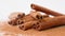 Close up studio shot of food ingredient. A pile of brown dried cinnamon sticks laying on the white background with