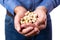 Close Up Studio Shot Of Mature Man Holding Handful Of Pistachio Nuts