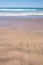 Close up study of waves and sand patterns at Makorori Beach, near Gisborne, New Zealand