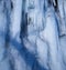 CLOSE UP Stunning frozen waterfall icicles on rocky mountain cliff on winter day