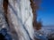 CLOSE UP Stunning frozen waterfall icicles on rocky mountain cliff on winter day