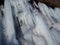 CLOSE UP Stunning frozen waterfall icicles on rocky mountain cliff on winter day