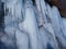 CLOSE UP Stunning frozen waterfall icicles on rocky mountain cliff on winter day