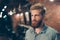 Close up of a stunning look of a red bearded guy with trendy hairdo in a barber shop. Looking so fashionable and confident