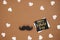 Close up of stylish black paper photo booth props moustaches, many little hearts and card with phrase happy father`s day