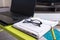 Close up of stylish glasses lying on the laptop table