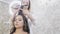 Close-up, stylist works in her beauty salon, a make-up artist, a hairdresser made an evening make-up for the client, and