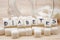 Close-up on sugar cubes spilled from overturned glass sugar bowl with text diabetes on cubes