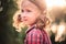 Close up summer outdoor portrait of cute smiling child girl in plaid dress