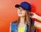 Close up summer portrait of attractive young woman wearing a blue baseball cap