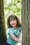 Close up summer portrait of a cute pretty smiling preschool girl with tangled hair.