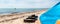 Close-up surf board and kite equipment on sand beach shore watersport spot on bright sunny day against sea ocean coast