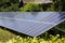 Close-up surface of lit by sun modern saving efficient stand -alone blue shiny solar photo voltaic panels system producing