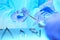 Close-up of of surgeons hands at work in operating theater toned in blue