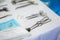 Close-up surgical instruments on a medical table in a clinic during surgery. Metal sterile scissors, clamp, surgical