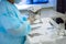 Close-up surgical instruments on a medical table in a clinic during surgery. Metal sterile scissors, clamp, surgical